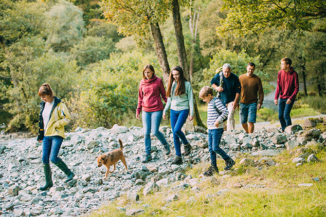 Friends hiking through a park on a gravel trail